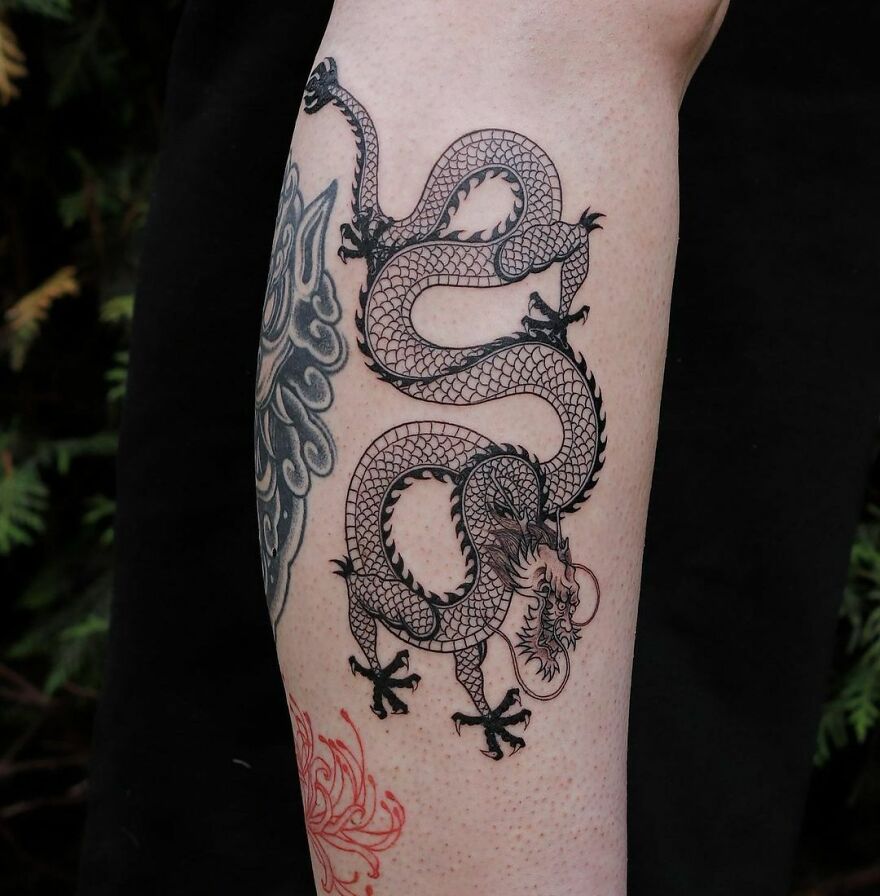 calf tattoo of a chinese dragon in black ink