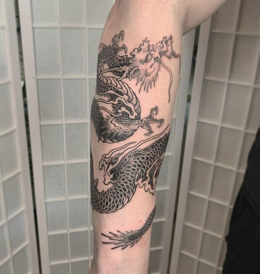 forearm tattoo of a black ink Chinese dragon