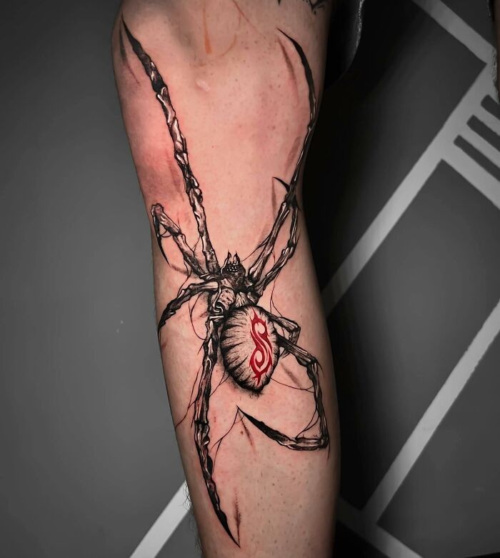 Dark spider tattoo on leg