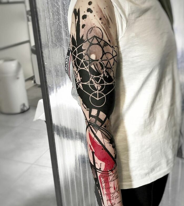 Abstract black and red Trash Polka arm sleeve tattoo
