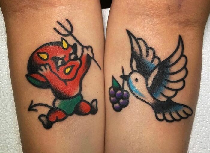 American traditional tattoo designs featuring a cartoon devil and a bird with grapes on skin.