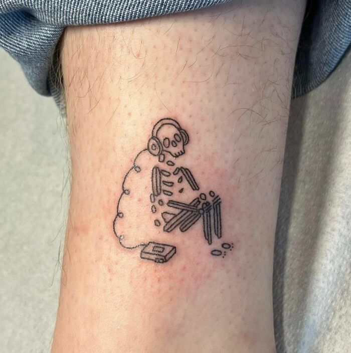 Handpoked music loving skeleton tattoo
