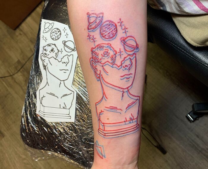3D space statue arm tattoo