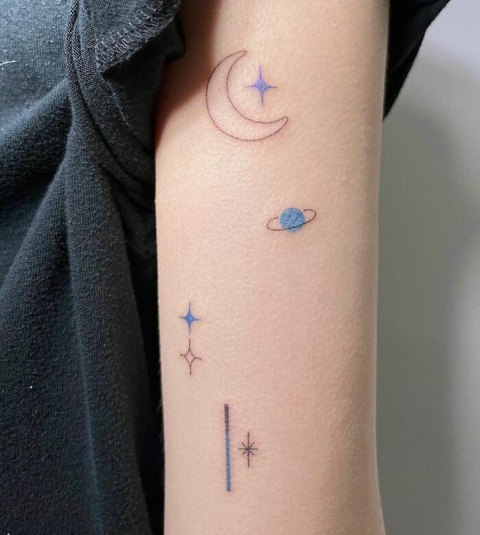 Tiny moon and Saturn arm tattoo