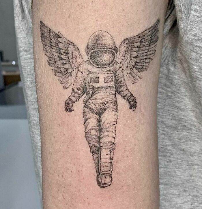 Angel astronaut arm tattoo