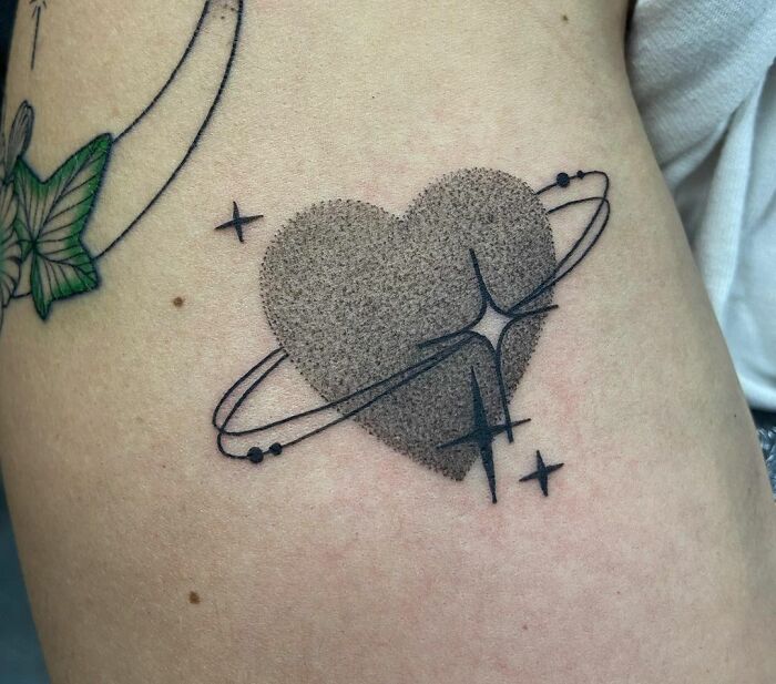 Sparkly heart planet tattoo