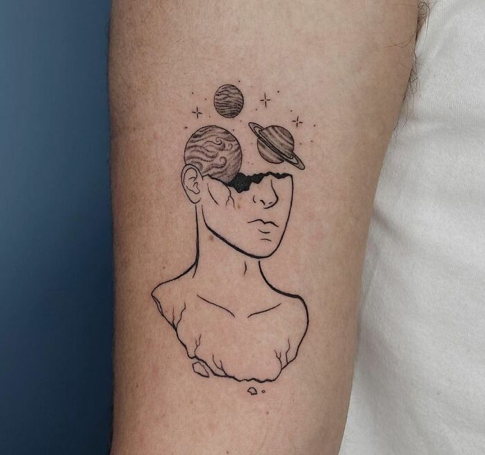 Space head arm tattoo