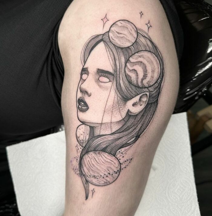 Planet lady arm tattoo