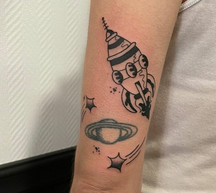 Spaceship arm tattoo