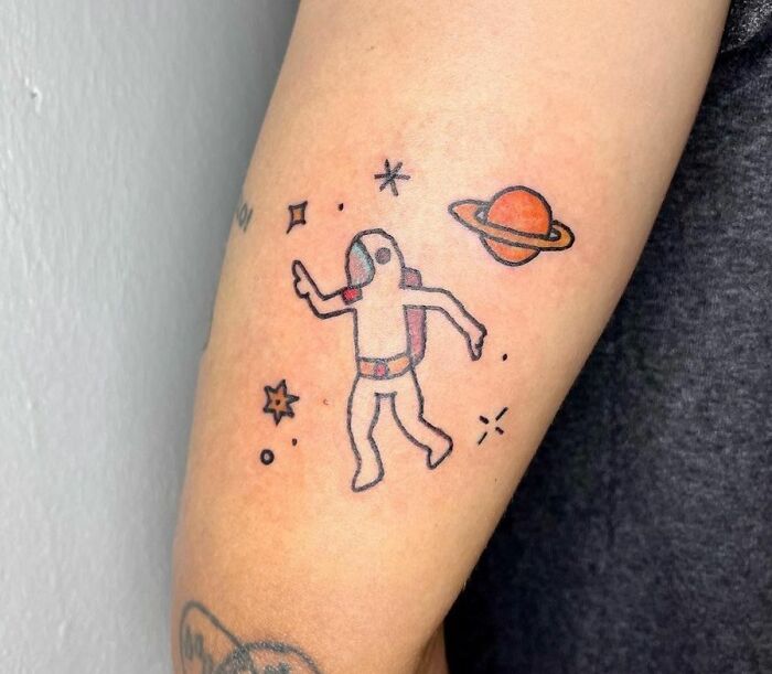 Cute astronaut arm tattoo