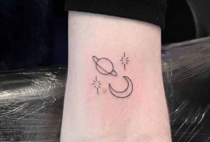 Tiny moon and Saturn arm tattoo