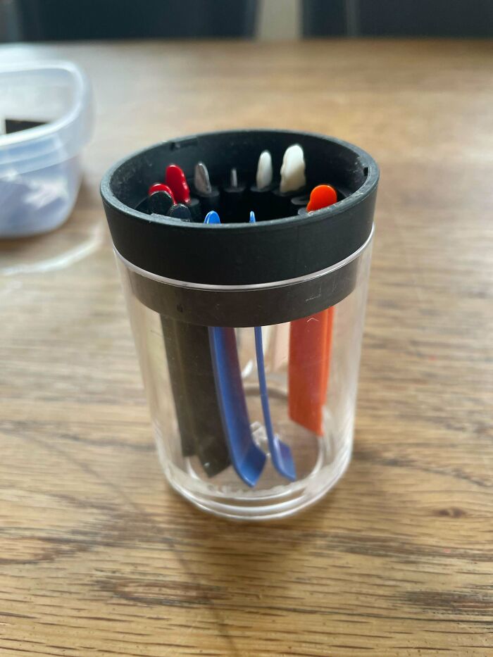 What Is The Purpose Of This Plastic Cup/Cannister? Flat Plastic Sticks With A Curved End Are Attached To The Lid, In Colored Sets Of Two. It's Possible To Take The Sticks Out Of The Lid