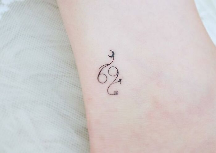 Cancer and moon ankle tattoo