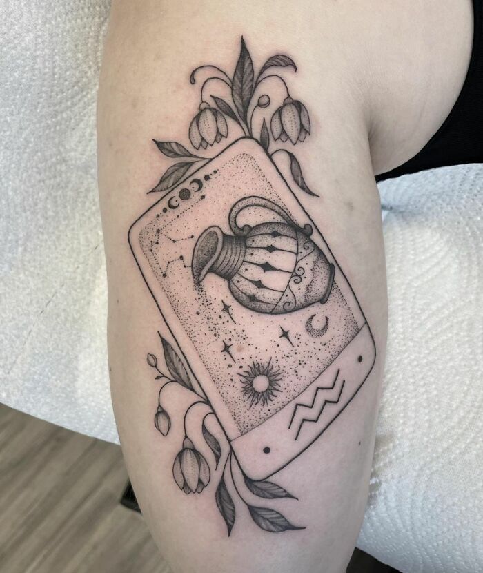 Aquarius water bearer and flowers tattoo