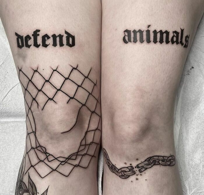 defend aninmals gothic lettering tattoo