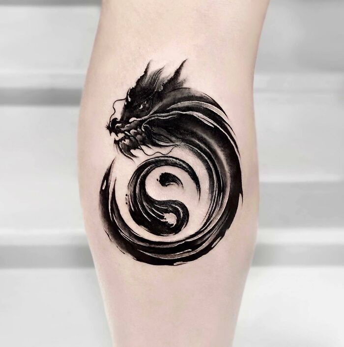 Dragon around yin yang symbol tattoo