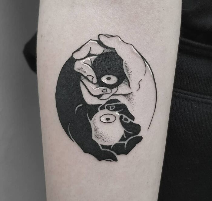 Two hands holding eyeballs tattoo 