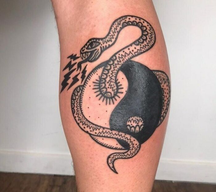 Snake coming out of a yin yang symbol tattoo