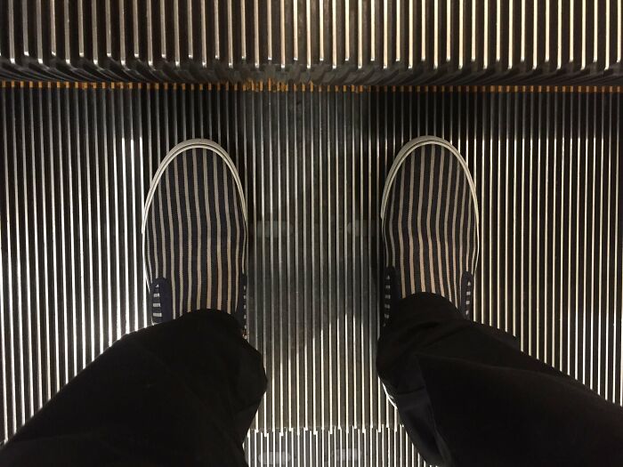 Aligned Shoes' And Escalator' Stripes