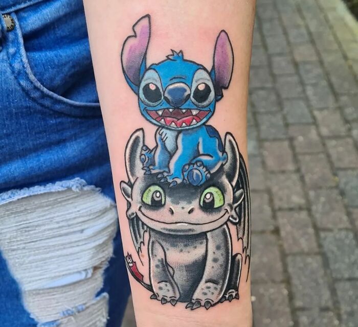 Stitch and Toothless forearm tattoo