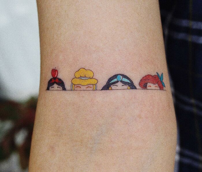 Disney princesses arm tattoo