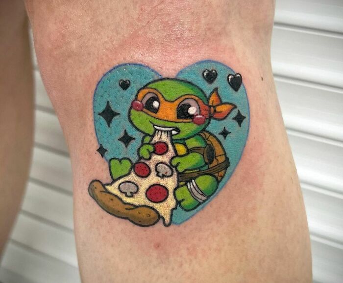 Cute Teenage Mutant Ninja Turtle eating pizza tattoo