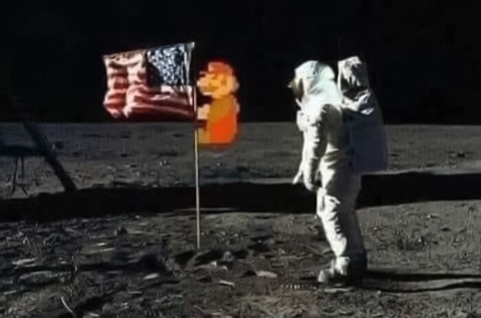 Mario holds onto the American flag pole that is on the moon
