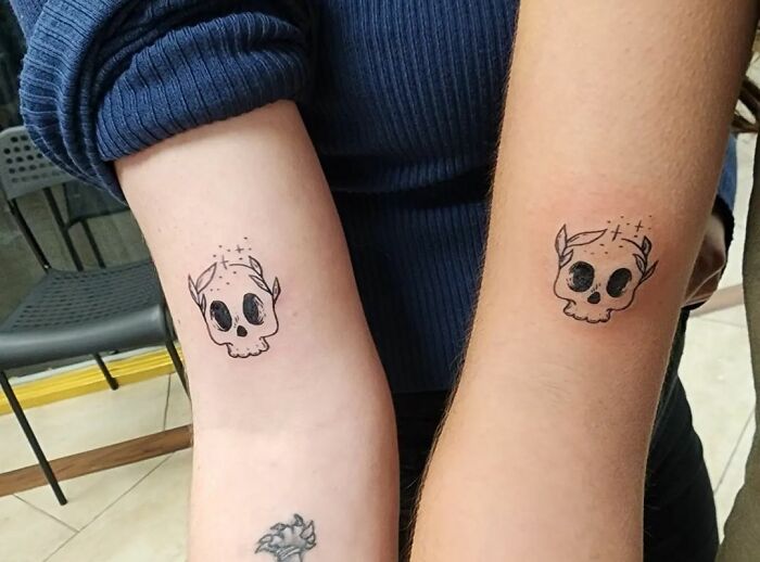 Cute matching skull arm tattoos