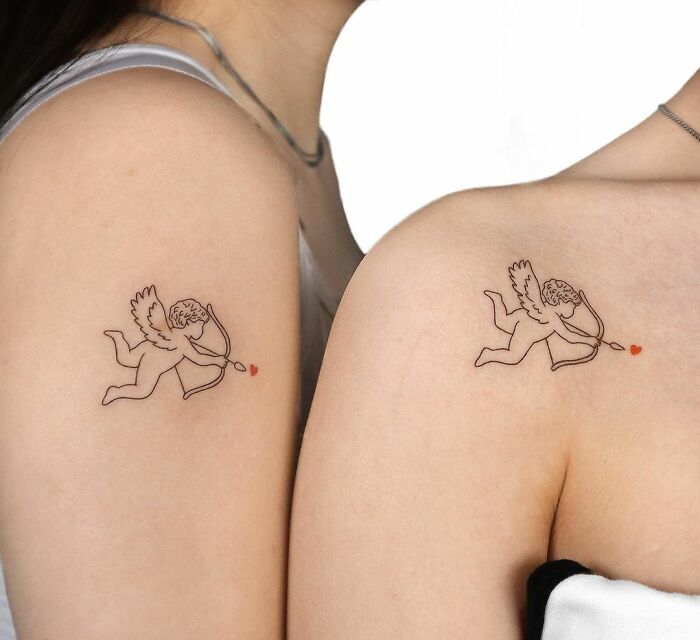 Matching cupid shoulder tattoos
