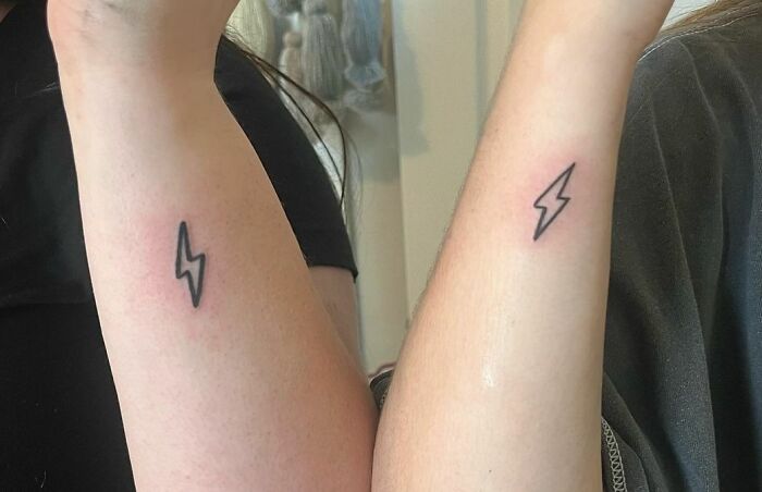 Matching lightning wrist tattoos