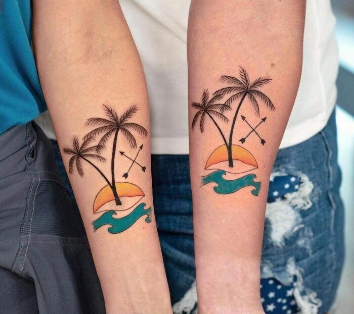 Matching palms with sun and sea arm tattoos