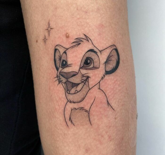 Cute Simba from The Lion King arm tattoo