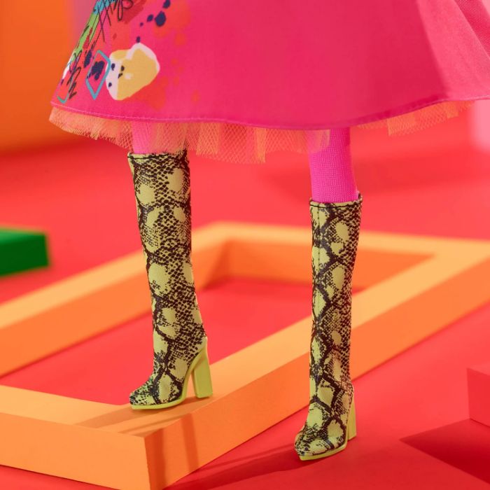 Weird Barbie doll in snakeskin boots, colorful dress, inspired by Mattel's latest movie release. Weird Barbie doll in snakeskin boots, colorful dress, inspired by Mattel's latest movie release.