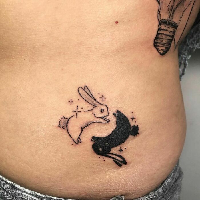 Yin yang in bunnies form tattoo 