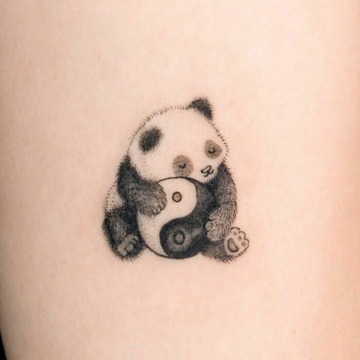 Panda hugging yin yang symbol tattoo