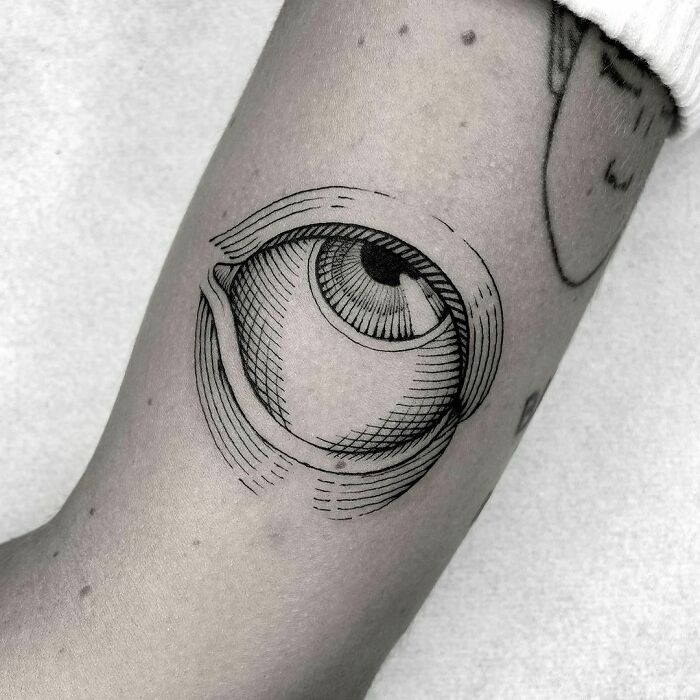 Eye looking up line work arm tattoo
