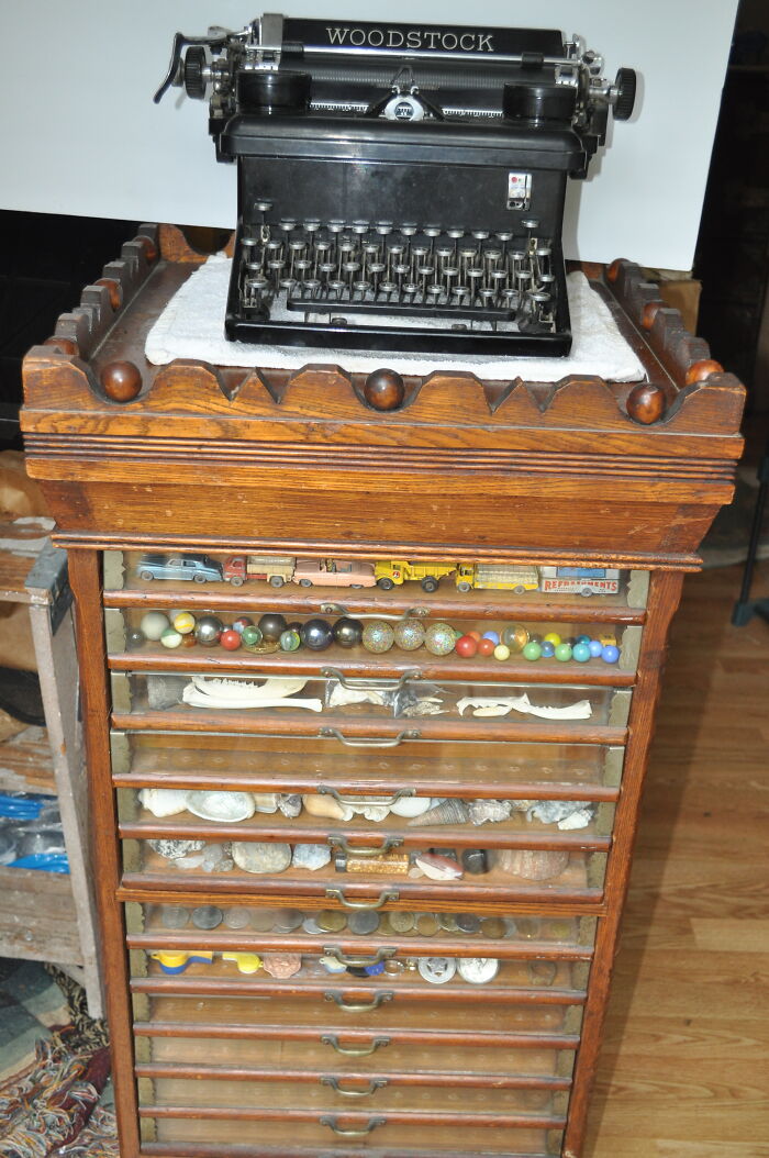 Woodstock Typewriter - 1930s - Belonged To My Grandmother. I Used To Play With It In The 60s. Antique Sewing Thread Display Case From A Department Store. Late 1800s. Bonus - Whatever You Can See In The Drawers (Lol). Dinky Toys Cars, Antique Marbles, Bones, Seashells, Foreign Coins, Misc