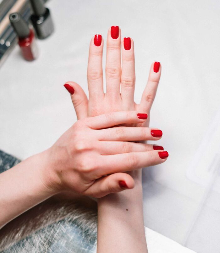 Hands with red nail polish