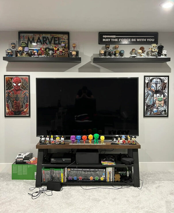 Funko Pop collection displayed on television table and floating shelfs