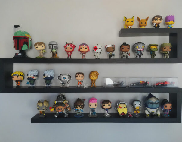 Funko Pop collection displayed on ledge shelf