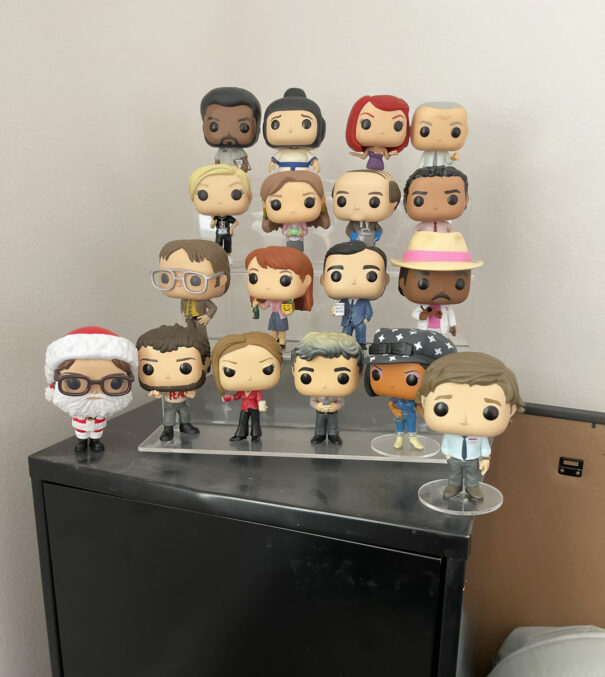 The Office Funko Pop collection displayed on acrylic stand shelf