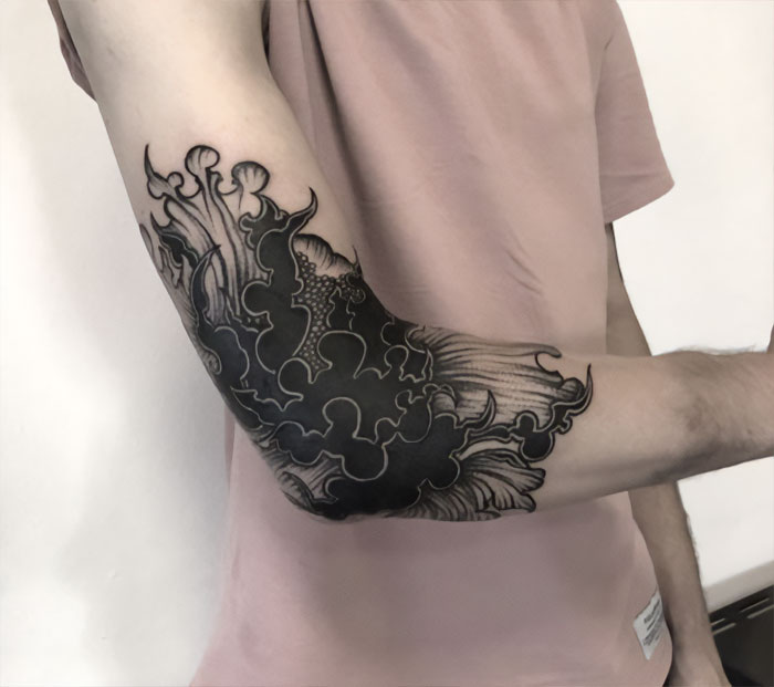 Black and white elbow tattoo
