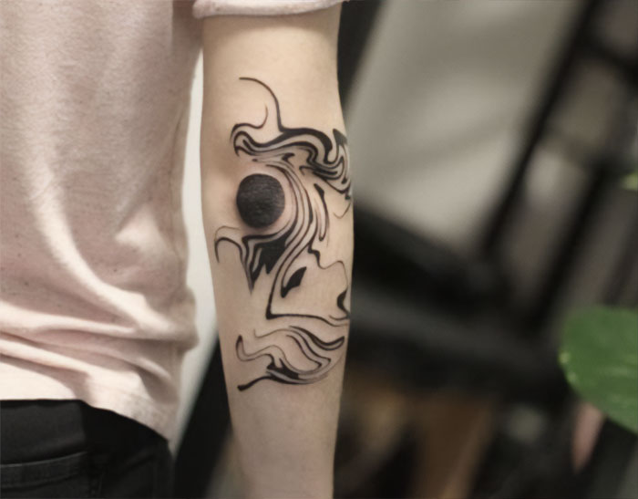 Trippy elbow tattoo