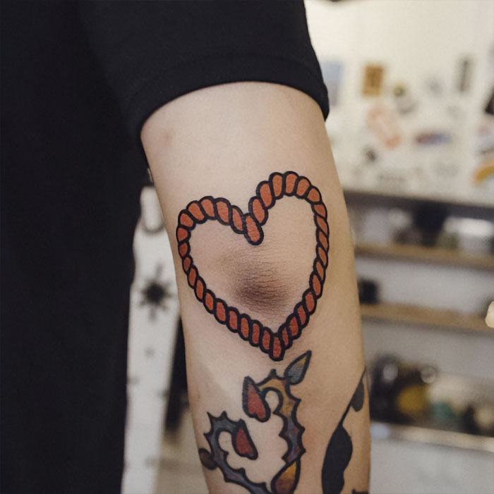 Heart from wire elbow tattoo