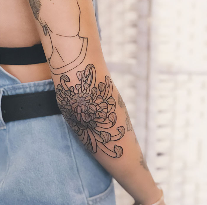 Lilly elbow tattoo