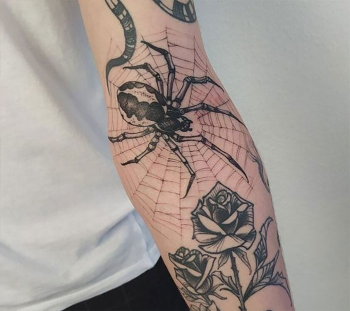 Spider and web elbow tattoo