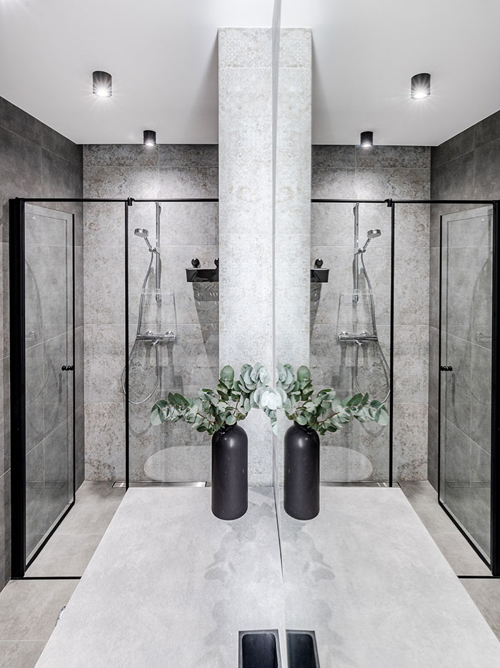 Mirror Reflection Of A Modern Grey And Black Bathroom