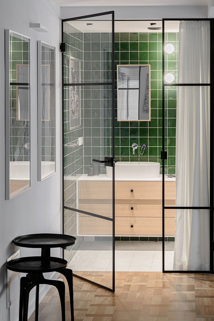 Glass Doors On An Entrence To A green Bathroom