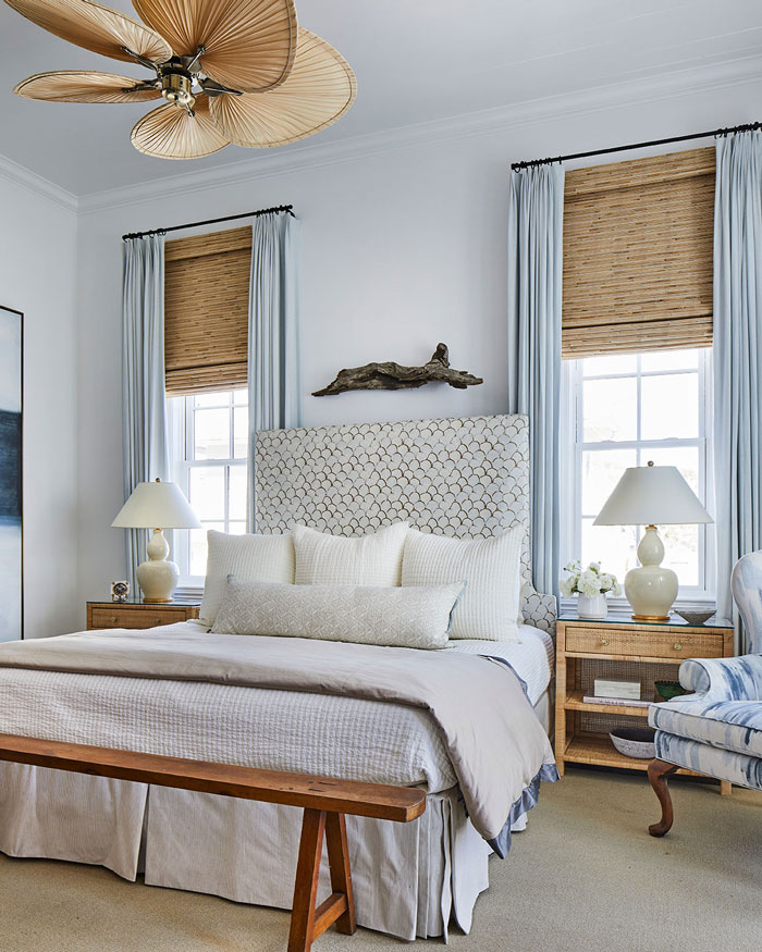 Light coastal bedroom with light blue curtains and wooden details