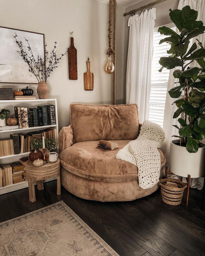 Cozy library nook with bookshelves and a light brown armchair